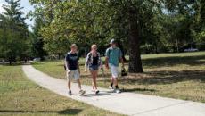 Students walking down a sidewalk on campus